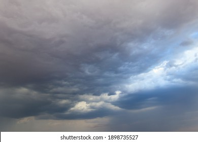 Dark storm clouds in sky before thunderstorm and rain. Dramatic sky background