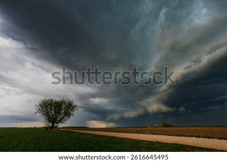 Dark storm rolling through the fields in Lithuania, dark supercell storm clouds