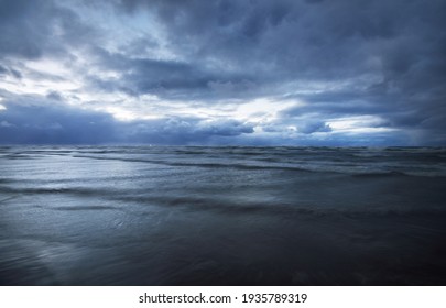 Dark storm sky above the Baltic sea, waves and water splashes. Dramatic cloudscape. Nature, environment, fickle weather, climate change. Atmospheric scenery. Panoramic view, long exposure - Powered by Shutterstock