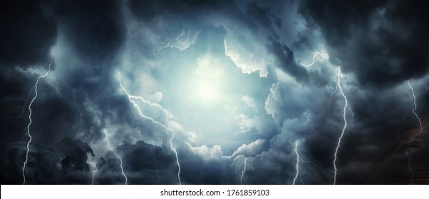 A dark stormy sky with dark clouds and lightning and the sun breaking through the clouds. Concept on the theme of religion, faith, hope, etc. The sun as a symbol of freedom.