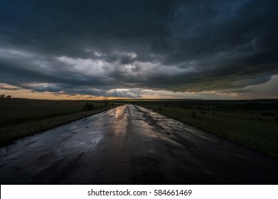 Dark Stormy Sky And Clouds And A Wet Road In The Rain