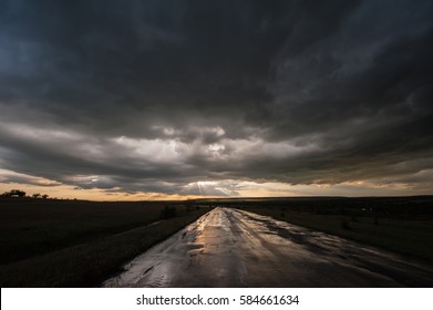 Dark Stormy Sky and Clouds and a Wet Road in the Rain. Rainy Weather. Spring Evening.