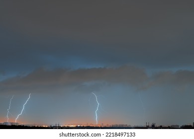 Dark Stormy Sky With Flashes Of Lightning Above The City.