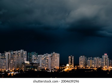 A Dark Stormy Sky Over Dusk Residential District Of The Kyiv City. Ukraine. An Illuminated City Street In The Evening Before The Coming Heavy Rain.