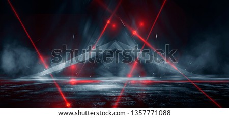 Dark street, reflection of neon light on wet asphalt. Rays of light and red laser light in the dark. Night view of the street, the city. Abstract dark blue background.