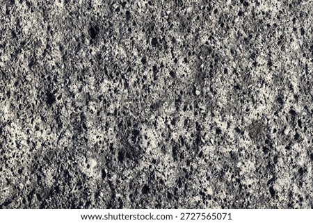 a dark surface background on rough, irregular, abstract rocks 