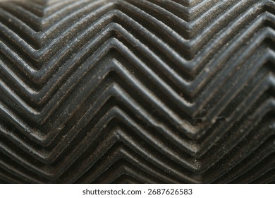 dark surface with herring bone pattern or zigzag pattern                                   