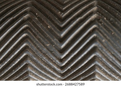 dark surface with herring bone pattern or zigzag pattern                                 