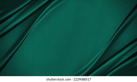 Dark teal emerald green silk satin. Shiny smooth fabric. Soft folds. Luxury background with space for design. web banner. Flat lay, top view table. Birthday, Christmas, Valentine, New year.