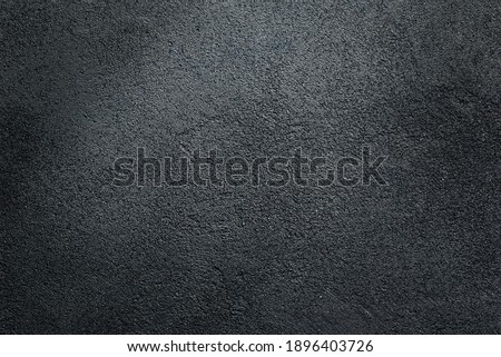
Dark textured asphalt black background.
