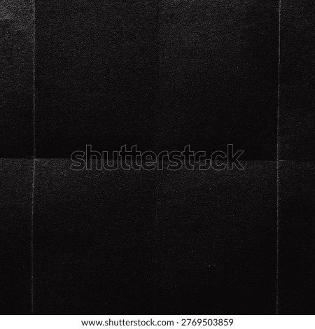 Dark, textured black background with subtle grid lines, creating a sleek and modern appearance.