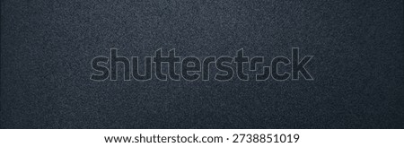 A dark textured surface is displayed, suitable for backgrounds or artistic projects. It shows small texture variations across the area.