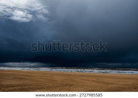 Dark, threatening rain clouds over the beach of Katwijk aan Zee in the Netherlands