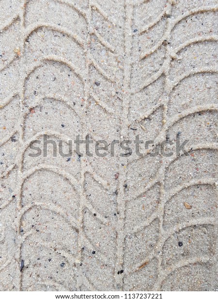 Dark tire tracks background Close-up\
tire tracks truck on a dirt road in daylight wheel\
track