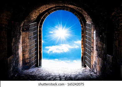 Dark tunnel corridor with arch opening to the sun. Light at the end of the tunnel.