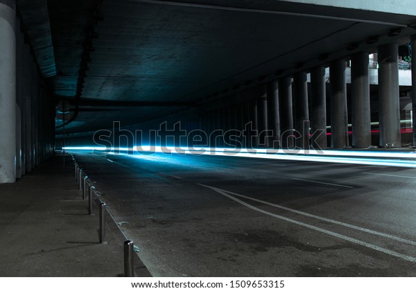 Dark tunnel with a fast passing car. Light line\
through a dark tunnel