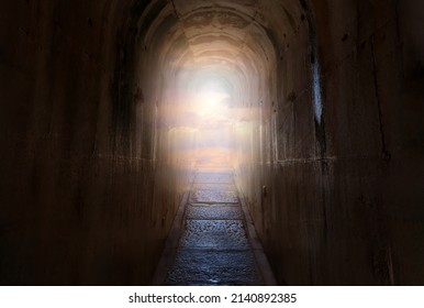 Dark tunnel with narrow path and end of the path shining sky and clouds. Heaven or paradise religion concept. - Shutterstock ID 2140892385