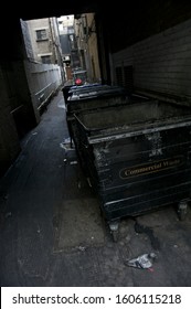 Dark View Of Dingy Back Alley With A British Garbage Dumpster In Soho, London