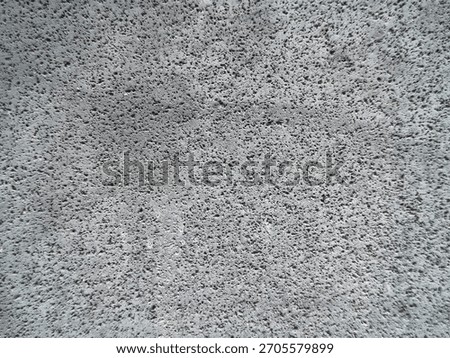 Dark Volcanic Rock Texture Background. Rough Porous Lava Stone Surface with Tiny Holes. Gritty Concrete or Pumice Stone Abstract Pattern.