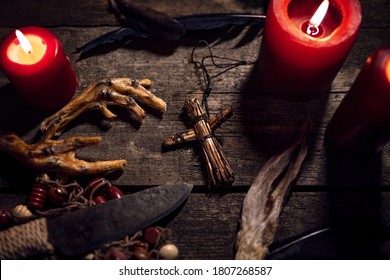 Dark Voodoo or vodun ritual with puppet, crow´s feet and knife, african witchcraft and religion