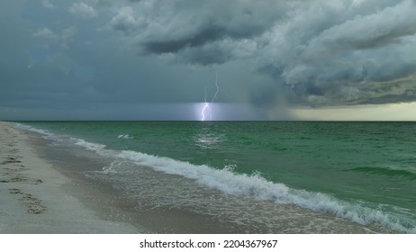 Dark Weather Front Clouds Forming On Stormy Sky During Heavy Rainfall Season Over Sea Water In Summer Evening