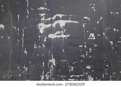 Dark, weathered wall surface featuring chipped white paint spots and random scratches, creating a rugged urban background. Ideal for design projects needing texture, grunge, or distressed look.