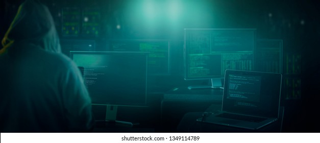 dark web hooded hacker  in his den  - Shutterstock ID 1349114789