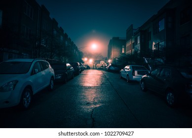 Dark Wet City Street With Cars At Night With Fog.