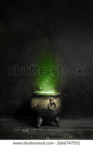 Dark witch cauldron with a magi.c witch's potion in a dark room