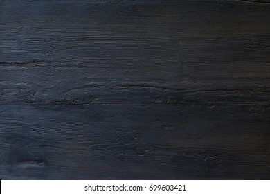 Dark wood background surface with old natural pattern or wood table top view. Grunge surface with wood texture background. Vintage timber texture background. Rustic. Balck texture