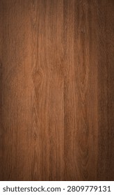 Dark wood background texture. Rustic wooden surface grain of deep brown board top view.