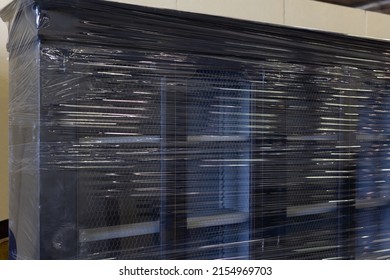 Dark Wood Cabinet With Showcases Packed With Cellophane To Be Transferred.