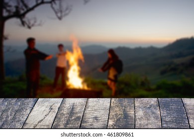 Dark wood desk space and night camping in forest background. - Shutterstock ID 461809861
