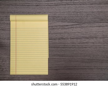 Dark Wood Desk, Yellow Notepad