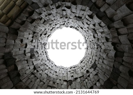 Dark wooden pattern with circle. Background with wood pieces. Art by Nikolai Polissky in Kaluga region, Russia. Contemporary architecture. Modern art. Black round window. Wooden backdrop. Wood pattern