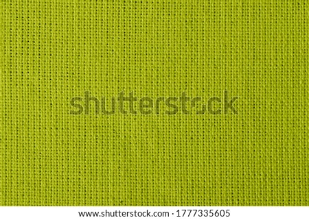 Dark yellow background with checkered pattern, closeup. Structure of the Dark yellow fabric with natural texture. Cloth backdrop.