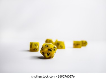 Dark yellow dice set often used for tabletop gaming such as Dungeons and Dragons or Magic the Gathering. The dice keep track of important information, the D20 often keeps track of the players health.