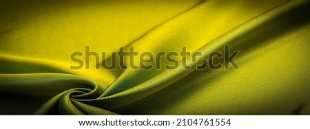 dark yellow fabric, silk fabric, dense weaving, photo studio. Amber, olive color, play of light and shadow make this photo unique. texture, background, pattern, pattern