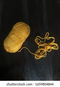 Dark Yellow Yellow Yarn Unraveling From Skein.