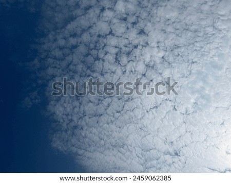 Darkblue sky with white clouds.