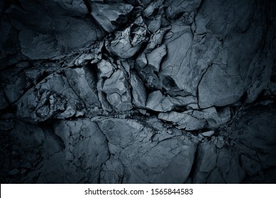 Darkened Background Of A Black Rock Wall
