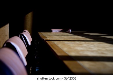 Darkened Boardroom With Heavy Shadows, Cold And Uninviting And Empty Seats