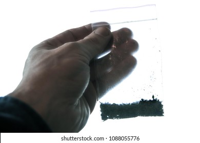 The Darkened Hand Holds A Bag Of Synthetic Marijuana