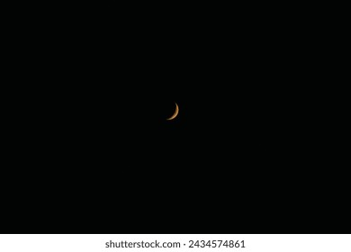 The darkened moon is yellow, eclipse. Crescent moon, moonlit sky, night, darkness. Phase, cycle, astronomy, astrology. Luna in the sky.
