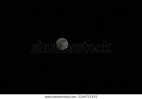 A darker moon in a darker
sky