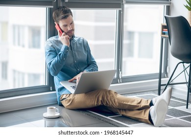 Dark-haired man working in the office and looking busy