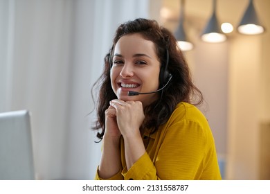 Dark-haired Woman In A Mustard Shirt Smiling Nicely