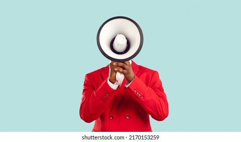Dark-skinned man hiding his face behind loudspeaker makes loud advertisement on pastel light blue background. Unknown man in red elegant jacket loudly announces crazy discounts. Advertisement concept.