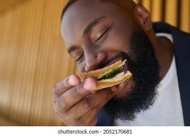 A dark-skinned maneating snadwich with a big appetite