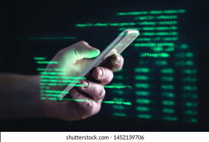 Darkweb, darknet and hacking concept. Hacker with cellphone. Man using dark web with smartphone. Mobile phone fraud, online scam and cyber security threat. Scammer using stolen cell. AR data code.